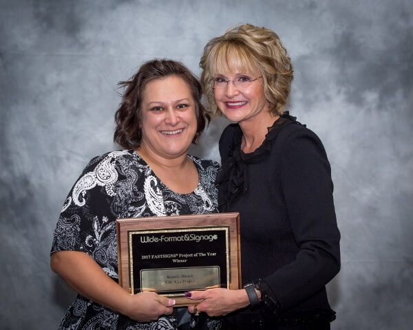 Karrie Brock smiles with Catherine Monson with her Project of the Year award